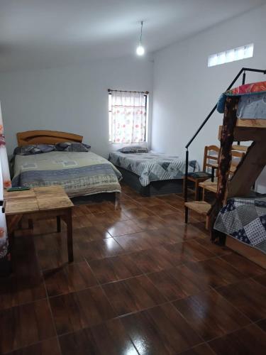 a room with two beds and a staircase in it at La Fábula-Verde Limón in Copacabana
