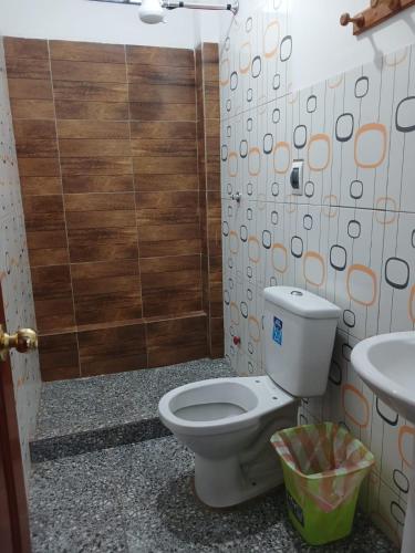 a bathroom with a toilet and a sink at La Fábula-Verde Limón in Copacabana