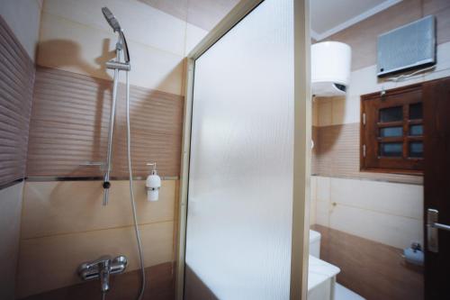 a shower with a glass door in a bathroom at Star Luka in Luxor