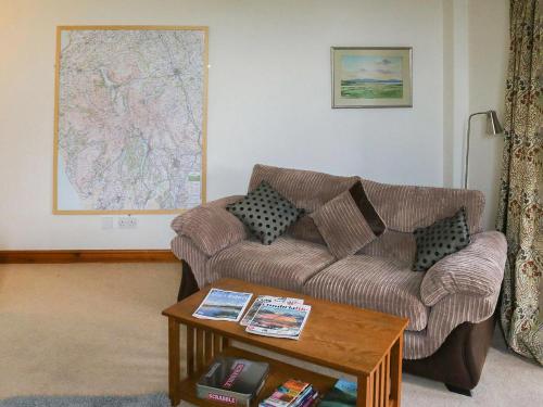 a living room with a couch and a table at Quarry Cottage in Penrith