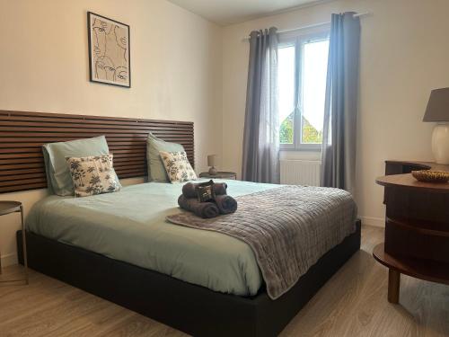 a bedroom with a bed with a teddy bear on it at Maison Familiale - 7 personnes - Parking privé & Jardin - Disney 24 min in Tournan-en-Brie
