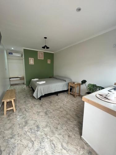 a bedroom with a bed and a table in it at Casa de Aire Ezeiza in La Unión