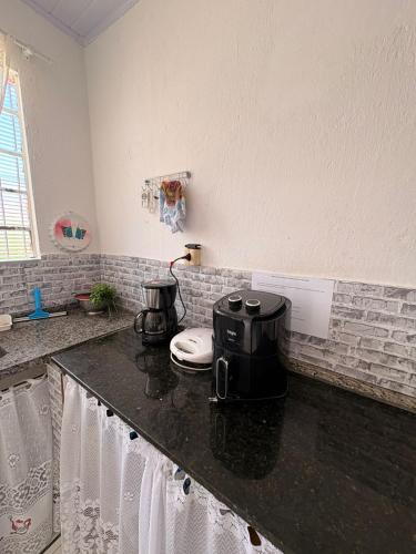 a kitchen with a counter top with two appliances on it at Chácara Pagliai e Bueno in Suzano