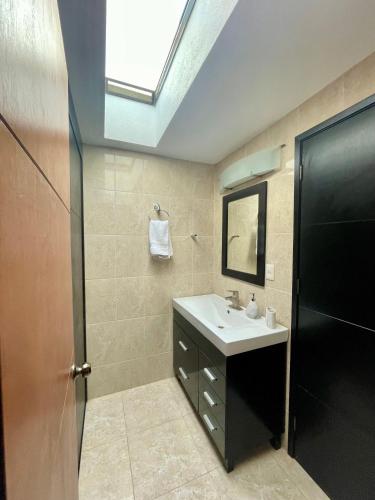 a bathroom with a sink and a mirror at Oasis Tequisquiapan in Tequisquiapan