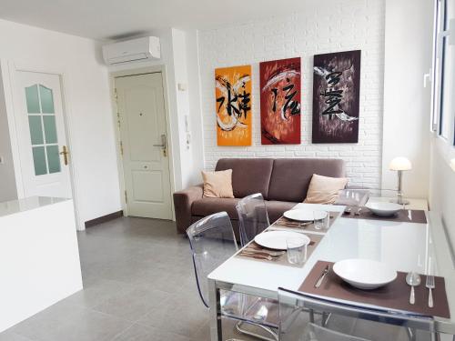a living room with a table and a couch at Suites Garden Apartamento 33 in Las Palmas de Gran Canaria