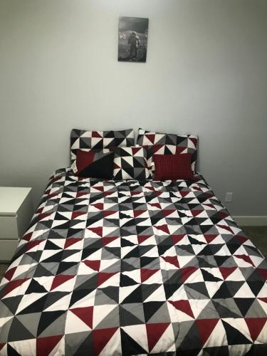 a bedroom with a black and white comforter on a bed at Utah Housing in South Jordan