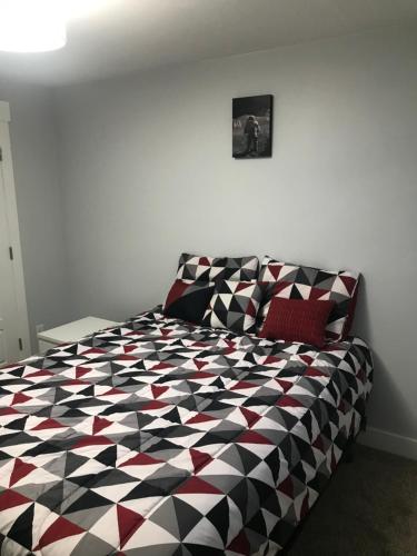 a bedroom with a black and white patterned bed at Utah Housing in South Jordan