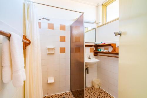 a bathroom with a shower and a sink at The Beach Hotel Whyalla in Whyalla