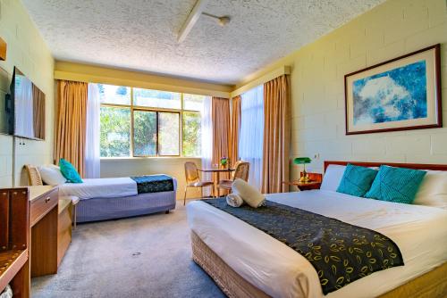 a hotel room with two beds and a window at The Beach Hotel Whyalla in Whyalla