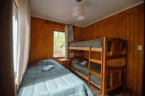 a bedroom with two bunk beds and a window at Nevisca 5p in Curacautín