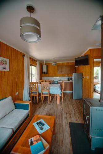 a living room with a couch and a table at Nevisca 5p in Curacautín