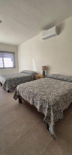 a room with three beds in a room at Suites EL FARO San Carlos in San Carlos