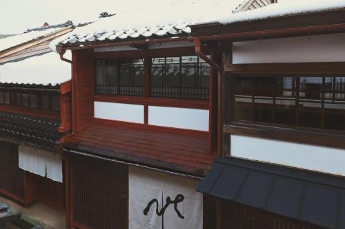a building with wooden windows and a roof at new tradition hotel kanazawa in Kanazawa