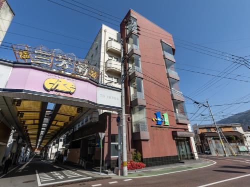 a building on the corner of a street at Awa Ikeda Station Hotel Eleven in Miyoshi