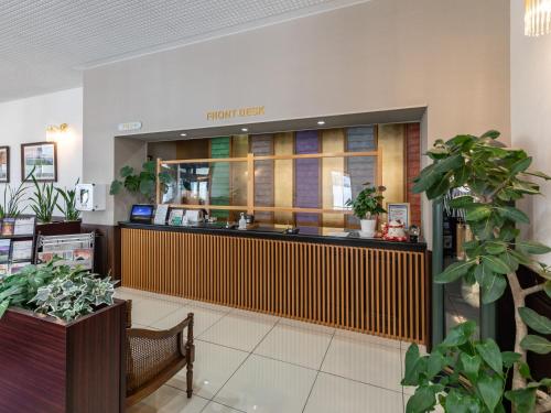 a front desk of a store with potted plants at Awa Ikeda Station Hotel Eleven in Miyoshi