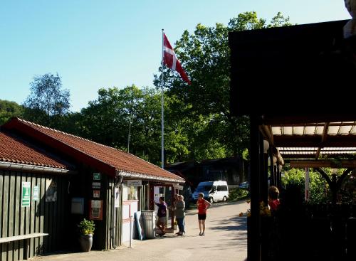 a group of people walking down a street with a flag at Randbøldal Camping & Cabins in Randbøl