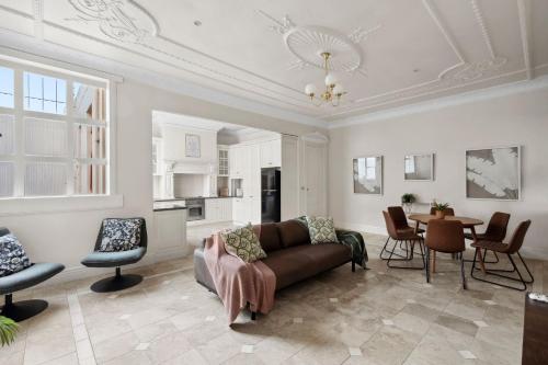 a living room with a couch and a table at 53 Malop by Regional Escapes in Geelong