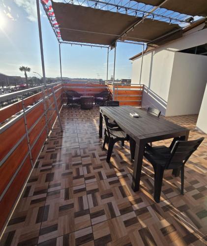 a wooden table and chairs on a boat at Hostal Las Cruces II in Arica