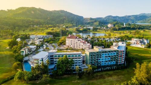 an aerial view of a resort with a lake at The Par Phuket Hotel in Kathu