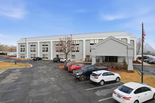 a large white building with cars parked in a parking lot at Hotel SLC in Salt Lake City