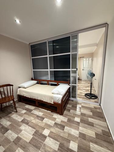 a bedroom with a bed and a glass wall at Temporario J & B in Paso de los Libres