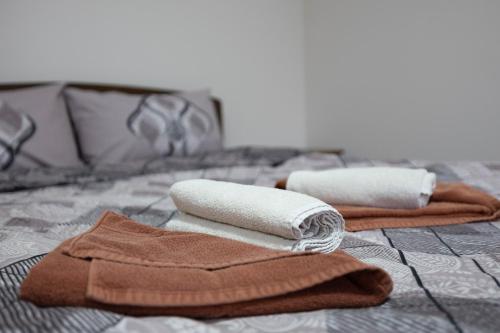 two towels sitting on top of a bed at Zlatni Klas in Zrenjanin