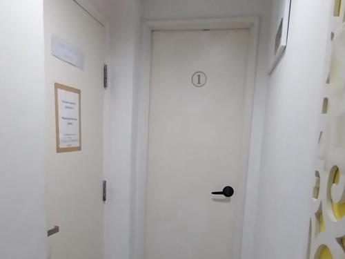 a white door with a black door knob on a wall at bnb's in Hong Kong