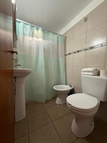 a bathroom with a toilet and a sink and a shower at Potrero Village Suites Refugios Serranos in Potrero de Garay