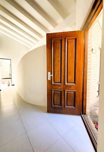 a wooden door in a room with a tile floor at 17 Rare Cool Urban-Style Nedlands 4BR-Parkng&Pool in Perth