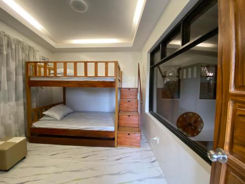 a bedroom with two bunk beds in a room at Casa Sandrine Resort in Malolos