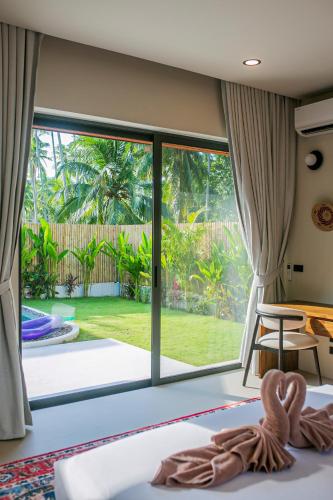 a room with a view of the garden at NOBELLA Villa, Luxury Boutique Hotel in Ko Phangan