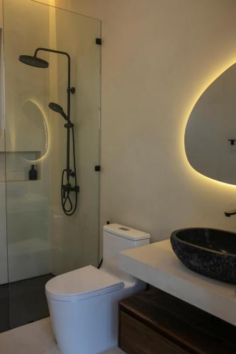 a bathroom with a white toilet and a sink at NOBELLA Villa, Luxury Boutique Hotel in Ko Phangan