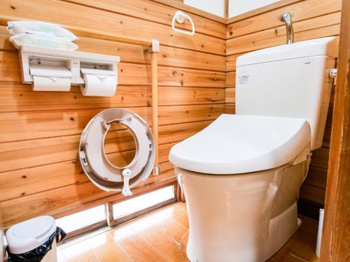 a bathroom with a toilet and wooden walls at Family Villa KASAMA - Vacation STAY 42429v in Kasama