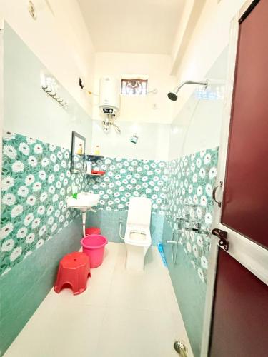 a bathroom with a toilet and a sink at Rameshwari Homestay in Lansdowne