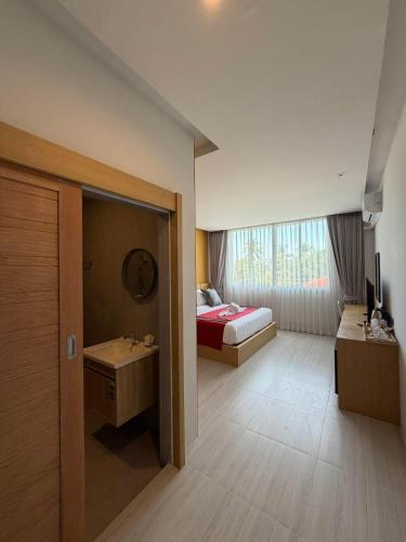 a hotel room with a bed and a bathroom at MM Hill Koh Samui Hotel - SHA Certified in Chaweng