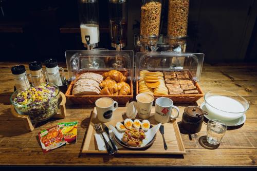 a table topped with trays of food and pastries at UNPLAN Shinjuku in Tokyo