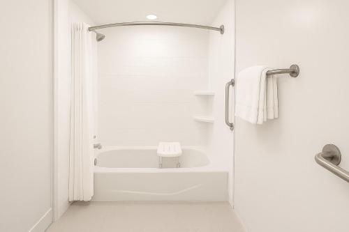 a white bathroom with a tub and a sink at Holiday Inn Express & Suites St George North - Zion in Washington
