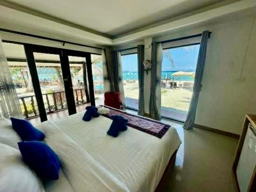 a bedroom with a bed with a view of the beach at Andaman Beach Resort by Zodiac in Ko Lipe