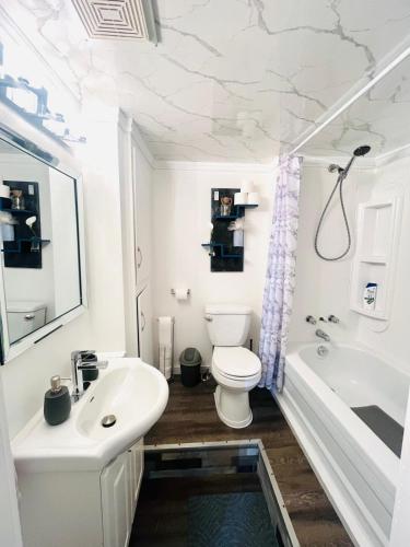 a bathroom with a toilet and a sink and a tub at Linda inn - Entire Unit- Sleep 3- Sherbrooke in Sherbrooke