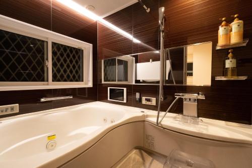 a large bathroom with a tub and a sink at A-PLAZA Yamanakako in Yamanakako