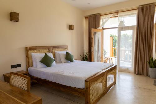 a bedroom with a large bed in a room at Beach House by Unrushed in Welhengoda