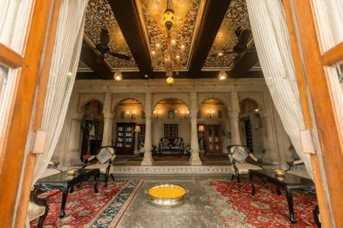 a large room with tables and chairs and a ceiling at BrijRama Palace, Varanasi - By the Ganges in Varanasi