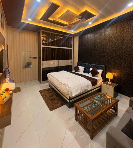 a bedroom with a bed and a couch and a table at Hotel Riverviewinn in Varanasi