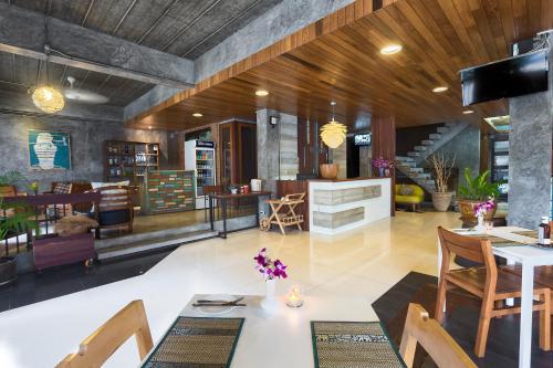 a living room with a table and chairs at Memory Patong - SHA Certified in Patong Beach