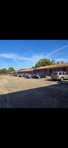 a row of cars parked in front of a building at Candle Light Motel in Ozark