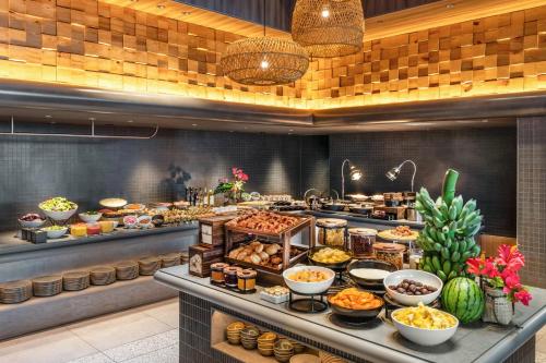 a buffet line with many different types of food at The Royal Park Hotel Iconic Naha in Naha