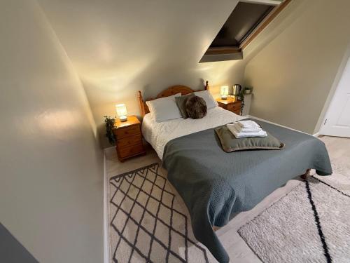 a bedroom with a bed with a cat sleeping on it at Heartbeat Cottage By Travel Lets Holiday Homes Letterkenny With Private Ensuite Rooms & Garden in Letterkenny