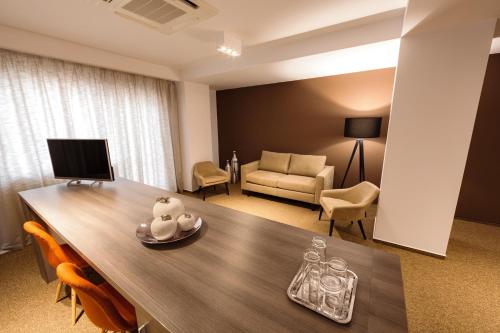 a living room with a table and a couch at Premium Wellness Institute in Bucharest