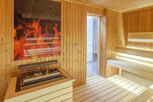 a sauna with a fire in it with a fireplace at Premium Wellness Institute in Bucharest