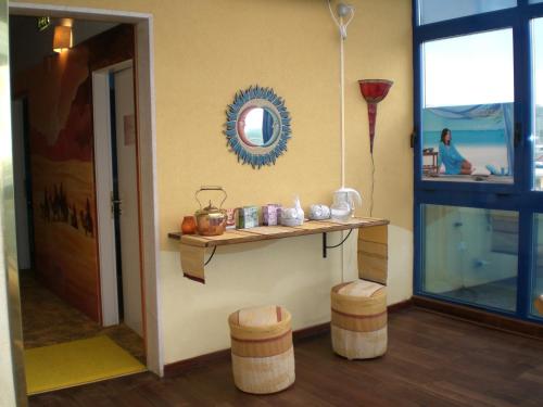 a room with a table and stools and a mirror at Dakar Living Hotel Vasto in Vasto